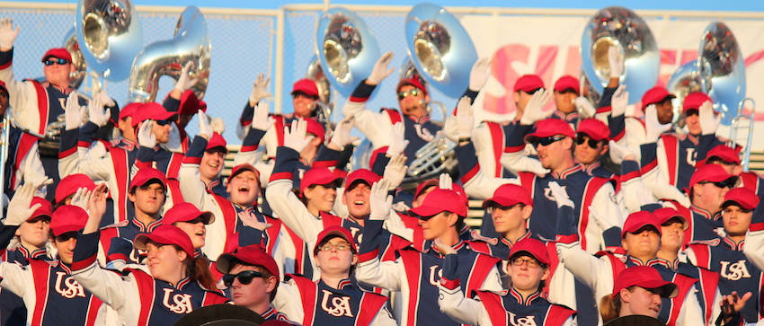 Band performing at game cheering.